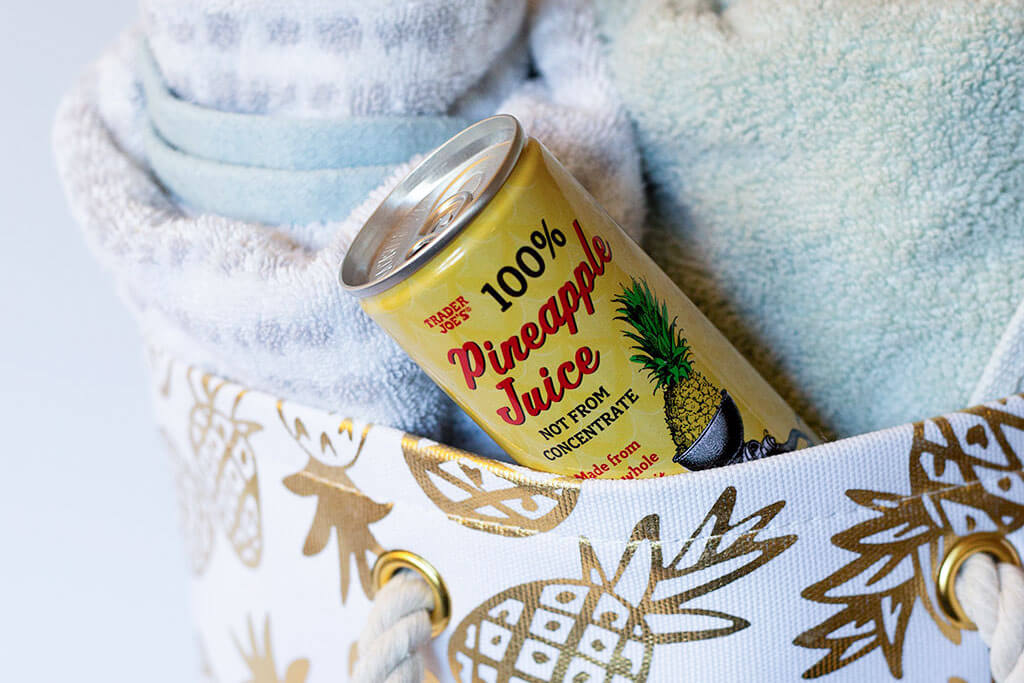 drive-swim-fly-pineapple-collection-gold-beach-bag-pineapple-juice-horizontal