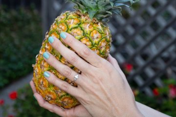 drive-swim-fly-pineapple-collection-real-fruit-holding-pineapple-hands-engagement-ring-wedding-ring-outdoors-backyard-header