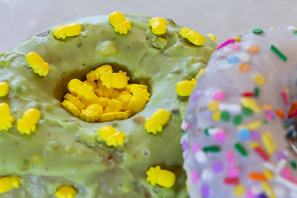 drive-swim-fly-pineapple-collection-stans-donuts-chicagoland-pistachio-donut-pineapple-sugar-sprinkles-icing-close-up
